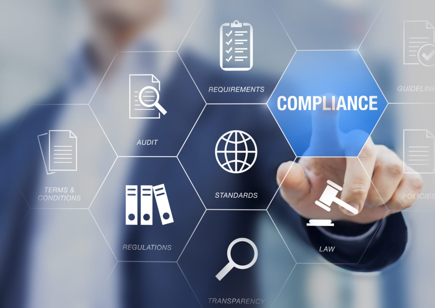 Businessman interacting with digital compliance icons on transparent screen.