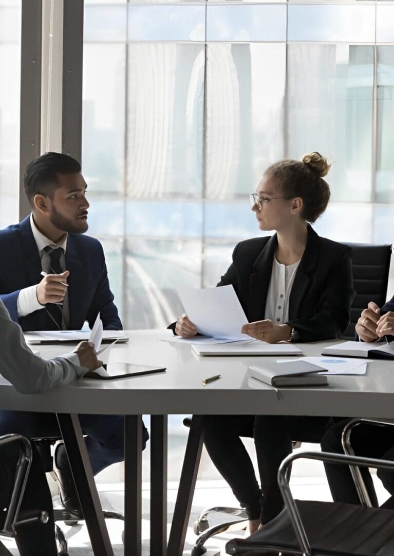 Business team discussing documents in a meeting room.